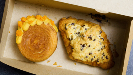 Cronut salted egg yolk New York roll with orange cream and chocolate chip crookie croissant are...