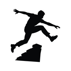 Silhouette of an athletic man leaping over rocks in an action shot