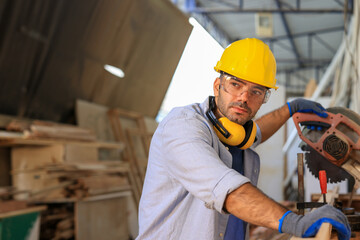 young male carpenter worker hold wooden plank at the carpentry workshop
