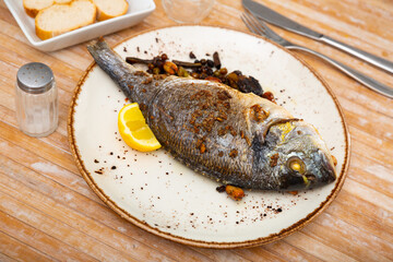 Delicious grilled gilthead bream (dorada) with lemon