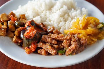**Nasi Rames, Indonesia, captured on August 6, 2025. Mixed rice dish with assorted side dishes like tempeh, vegetables, sambal, and curry, showcasing a colorful and flavorful everyday Indonesian meal