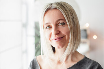 Portrait of Happy Middle Aged Woman standing in living room