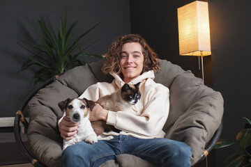 Man sitting on sofa with dog at home