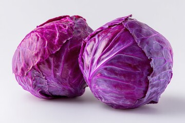 Obraz premium Two Vibrant Red Cabbages Showcasing Rich Purple Hues and Intricate Leaf Textures