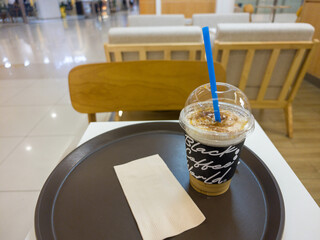 Refreshing Iced Coffee Beverage Served on a Tray in a Cafe Setting