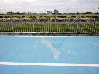 Urban Rooftop View with Blue Surface and Distant Cityscape Landscape