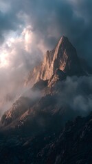 Fototapeta premium Beautiful mountain peak with dramatic lighting and fog