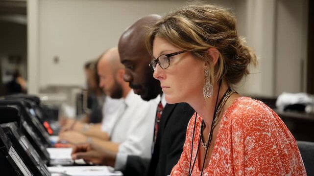 Professional court reporter attentively listens and types contestants statements on stenograph equipment while timestamping to maintain precise court documentation.