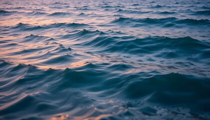 Fototapeta premium Close-up view of ocean waves at dawn or dusk. Gentle ripples and crests, muted colors