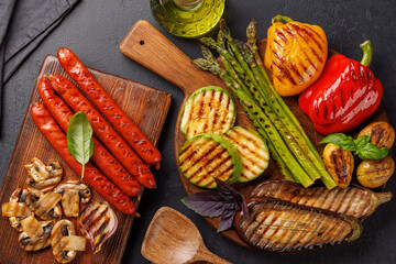 Assorted grilled vegetables including bell peppers, zucchini, eggplant, and sausages