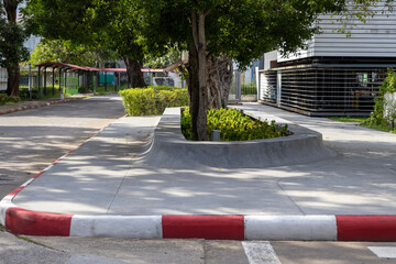 Modern sloped concrete seating in a public space designed to prevent water accumulation during rain. Ideal for urban planning, architecture, and infrastructure visuals.