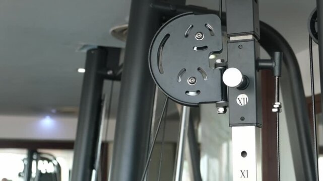 Strength training with cable machine equipment set up in a modern gym environment emphasizing fitness and workout routines for health enthusiasts.