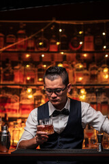 Bartender is pouring whiskey into a glass in a restaurant