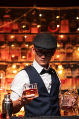 Bartender is pouring whiskey into a glass in a restaurant