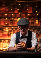 Bartender is pouring whiskey into a glass in a restaurant
