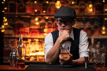 Bartender is pouring whiskey into a glass in a restaurant