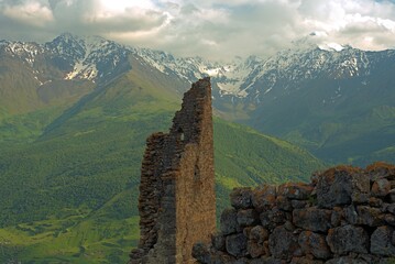 Ancient architecture and ruins against mountain background . Remains of a destroyed tower . North...