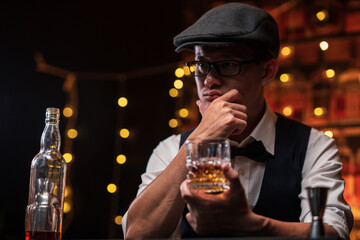 Bartender is pouring whiskey into a glass in a restaurant
