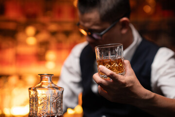 Bartender is pouring whiskey into a glass in a restaurant