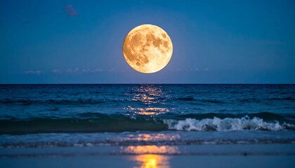 Large full moon over calm ocean at night