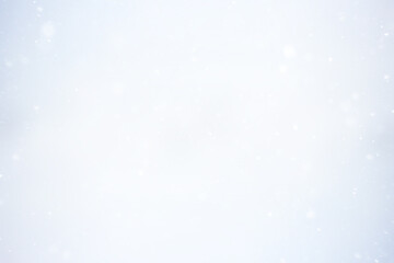 blurred snow / winter abstract background, snowflakes on abstract blurred glowing leaf background