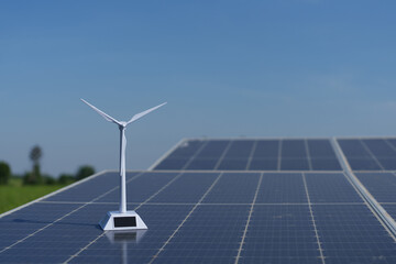 A model wind turbine placed on a solar panel.