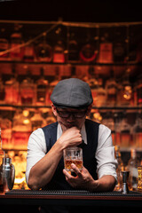 Bartender is pouring whiskey into a glass in a restaurant