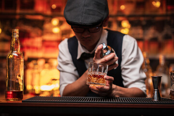 Bartender is pouring whiskey into a glass in a restaurant