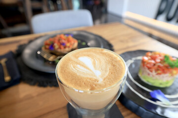 cappuccino, coffee in a clear glass cup in a cafe, soft color background food and drink, hot drink