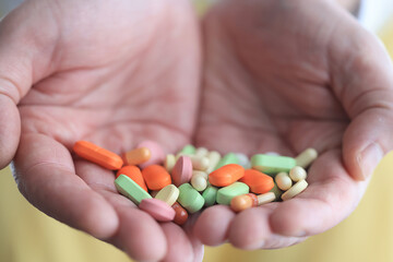 a lot of pills in the palm of a person's hand, medical background