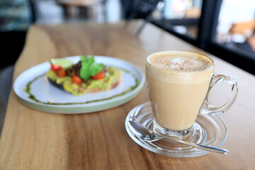 cappuccino, coffee in a clear glass cup in a cafe, soft color background food and drink, hot drink