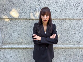 Executive woman with crossed arms and strong gaze
