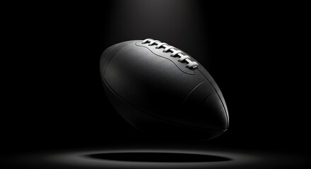 Black American Football Ball Suspended in Dark Space with Spotlight Effect