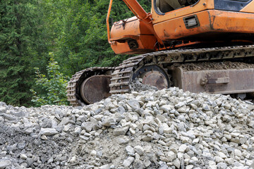  Excavator on a gravel heap