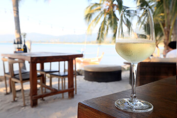 glass of cold white wine on the summer seashore by the water, relaxing by the water, a gentle background of soft color