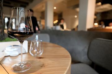 dinner in a restaurant with wine, beautiful table setting, a glass of wine in the foreground