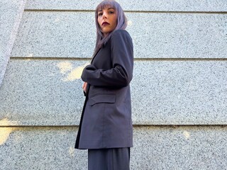 Side view of powerful woman in elegant suit