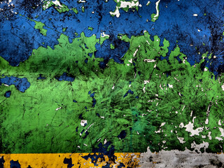 Scratches and cracks of a blue, green and yellow paint on a metal steel surface.