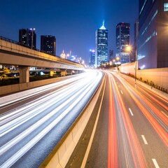 Fototapeta premium Night cityscape with light trails on a highway