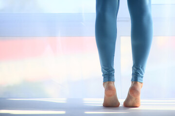 The girl is standing on her toes, legs in close-up