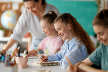 Happy kids and teacher at school