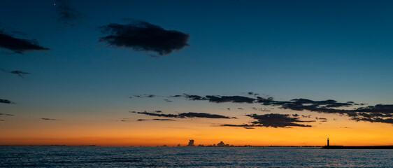 Serene Sunset Over Ocean with Lighthouse in Almeria