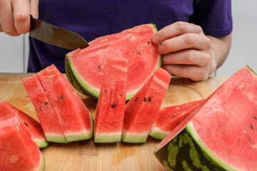 Cut red juicy watermelon into triangles