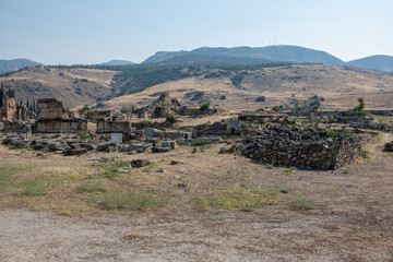 Discover the ancient ruins of Pamukkale set against a backdrop of rolling hills and dry landscapes,...