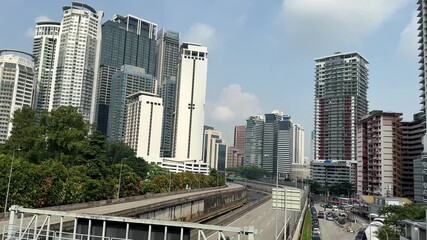 Malaysia, Kuala Lumpur, 24 November 2025 – urban infrastructure. Walking around the capital, skyscrapers, towers, Petronas, sights all around, large motorways, glass facade.