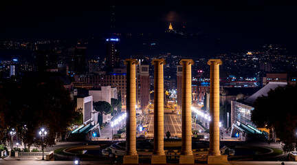 Illuminated Cityscape at Night with Columns in Barcelona, Spain