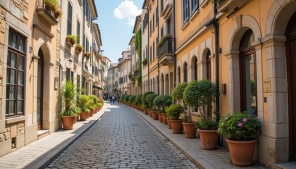 Obraz premium Charming Cobblestone Street in Italy, Picturesque European Architecture, Sunlit Alleyway with Lush Greenery, Tranquil Urban Scene