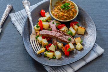 Lamb with smoky pepper sauce and saute potatoes