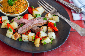 Lamb with smoky pepper sauce and saute potatoes