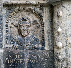 Historical Stone Carving with Playful Figure in Bayern, Germany